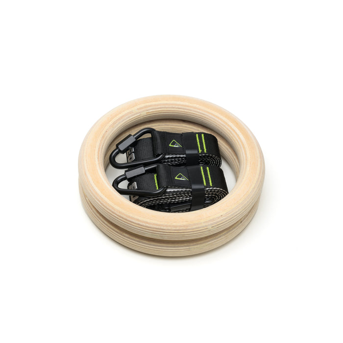 Duonamic wooden gymnastic rings with adjustable suspension straps for bodyweight training.